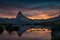 Sunset on dem Matterhorn and its reflection in a mountain lake