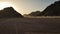 Sunset in the desert in Egypt. Mountain cliff in the desert at sunset. Nature and landscape