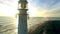 Sunset, drone and ocean with landscape of lighthouse nature, travel beacon and coastal landmark. Adventure, peace and