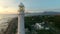 Sunset, drone and ocean with landscape of lighthouse nature, travel beacon and coastal landmark. Adventure, peace and