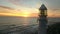 Sunset, drone and ocean with landscape of lighthouse nature, travel beacon and coastal landmark. Adventure, peace and