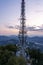 Sunset dusk view of telecom radio tower with antenna on top of Monte Salvatore in Lugano, switzerland