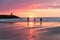 Sunset at the Dutch coast near Scheveningen with passing walkers