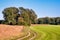 Sunset at a Dutch walking trail along lush green fields