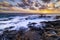 Sunset at El Bufadero natural blowhole on Gran Canaria. Ocean waves hiting rocks