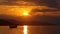 At sunset, the fisherman pulls the chain of his boat out of the sea. silhouette image.