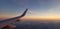 Sunset in flight in commercial airplane high above the clouds