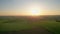 Sunset flyover: aerial journey over a tranquil farm field