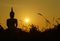 Sunset in front of a buddhist sculpture