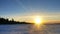 Sunset on a frozen winter lake