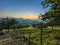 Sunset glow over far away mountains from a lush orchard.