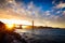 Sunset at the Golden Gate Bridge with sun starburst