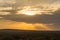 Sunset on the hills and a bed of palm trees in the Amboseli in K