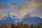 Sunset hitting snow covered mountains