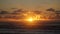 Sunset at Hokitika beach with clouds and golden sky on the South Island of New Zealand.