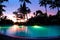 Sunset and illuminated swimming pool