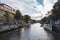 Sunset illuminates a water canal and adjacent buildings in the capital city of Amsterdam, the Netherlands