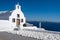 Sunset at the Island Of Santorini Greece, beautiful whitewashed village Oia with church and windmill during sunset