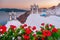 Sunset at the Island Of Santorini Greece, beautiful whitewashed village Oia with church and windmill during sunset