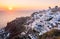 Sunset at the Island Of Santorini Greece, beautiful whitewashed village Oia with church and windmill during sunset