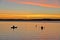 Sunset and kayakers in the bay