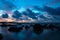 Sunset at Koh Lanta with Stones in the sea and Phi Phi islands in the horizon, Koh Lanta, Thailand, Asia