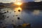 Sunset on the lake on a background of stones in a clear summer day. Warm summer evening on the lake. Fabulous views of the lake