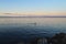 Sunset on the lake, calm water. Lake Geneva at sunset, Evian, France