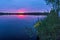 Sunset on the lake with flowers on the shore