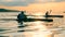 Sunset lake with a group of boaters crossing it