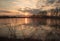 Sunset - lake - mirrored clouds, scrubs on shore