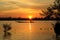 Sunset at Lake with silhouettes small fishing boat on foreground,select focus with shallow depth of field