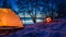 Sunset at the lake with tent and bonfire in winter