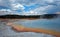 Sunset Lake under overcast cumulus clouds in Black Sand Basin in Yellowstone National Park in Wyoming USA