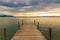 Sunset on lake with wooden pier on overcast day. Zug, Switzerland