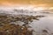 Sunset at the lakeside with rocks of a fjord during low tide in