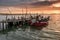 Sunset landscape of artisanal fishing boats in the old wooden pier