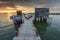 Sunset landscape of artisanal fishing boats in the old wooden pier. Carrasqueira is a tourist destination for visitors to the coas