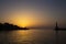 Sunset landscape in Chania\\\'s harbour with lighthouse silhouette on quiet Mediterranean waters