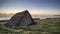 Sunset landscape image of seaweed drying hut at Freshwater West