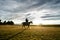 Sunset landscape with a man and his son riding horses.