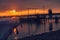 Sunset landscape with a silhouette of couples on a quay, outdoor