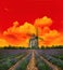 Sunset in lavender field. Landscape with windmill and dramatic s