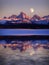 Sunset Light Alpen Glow on Tetons Teton Mountains wtih Moon Rising reflect reflection water pond lake