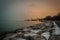Sunset light behind Chicago skyline with snow covered rocks acting as leading line