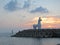 Sunset and lighthouse in the shape of horse on Jeju island in South Korea