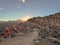 Sunset lighting up a rocky trail winding through an arid and dry landscape.