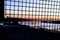 Sunset looking through wire at blur river