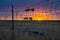 Sunset Looking Through Wire Livestock Fence with Tensioners