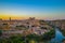 Sunset at lookout of Toledo, Spain. Tajo river around the city and Alcazar and Cathedral at background.